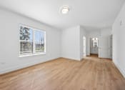 Thumbnail 47 of 60 - A room with wooden floors and a window with blinds.