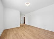 Thumbnail 48 of 60 - A room with wooden floors and white walls.
