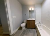 Thumbnail 13 of 61 - A white bathroom with a toilet, sink, and bathtub.