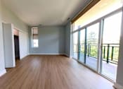 Thumbnail 14 of 61 - A room with wooden floors and sliding glass doors.