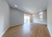 Thumbnail 7 of 61 - A room with wooden flooring and white walls.