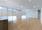 Thumbnail 6 of 61 - A room with wooden floors and white walls.