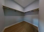 Thumbnail 10 of 61 - A room with a wooden floor and white walls.