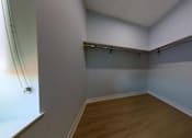 Thumbnail 9 of 61 - A room with a wooden floor and white walls.