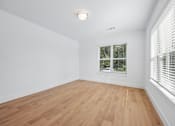 Thumbnail 49 of 60 - A room with wooden flooring and a window with blinds.