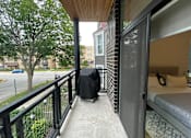 Thumbnail 16 of 45 - A balcony with a black railing and a mattress on a bed frame.