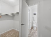 Thumbnail 19 of 37 - A white bathroom with a toilet and a door.