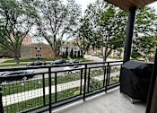 Thumbnail 17 of 45 - A balcony with a black railing and a black umbrella.