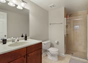 Thumbnail 27 of 31 - A bathroom with a toilet, sink, and shower.