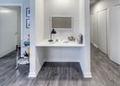 Thumbnail 6 of 31 - A white bathroom with a vanity and a mirror.