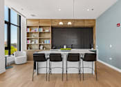 Thumbnail 42 of 84 - A kitchen with a bar area and chairs.