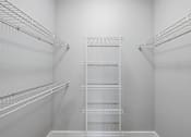 Thumbnail 19 of 34 - Empty white shelves in a room.