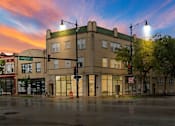 Thumbnail 2 of 15 - a building on the corner of a street at sunset
