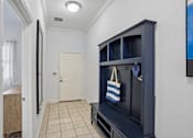 Thumbnail 10 of 46 - A room with a white door and a black cabinet.