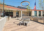 Thumbnail 73 of 84 - A patio with a table and chairs and a large umbrella.