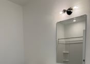Thumbnail 19 of 24 - A white bathroom with a toilet, sink, and mirror.