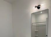 Thumbnail 23 of 24 - A white bathroom with a toilet, sink and mirror.