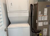 Thumbnail 24 of 24 - A white dishwasher and dryer are in a small room.