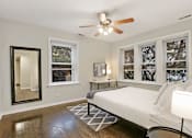 Thumbnail 14 of 15 - a bedroom with a large bed and a ceiling fan