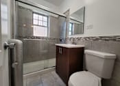 Thumbnail 7 of 15 - a bathroom with a toilet and a sink and a shower