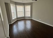 Thumbnail 11 of 17 - an empty room with a ceiling fan and three windows