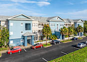 Thumbnail 2 of 27 - A row of houses with cars parked in front.