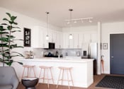Thumbnail 2 of 24 - A modern kitchen with a bar stool and a potted plant.