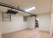 Thumbnail 13 of 17 - A room with wooden flooring and a window with blinds.