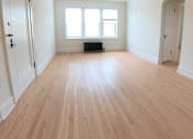 Thumbnail 8 of 13 - A room with wooden flooring and a ceiling fan.
