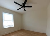 Thumbnail 13 of 13 - A room with a ceiling fan and a window with blinds.