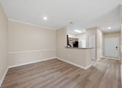 Thumbnail 23 of 34 - A room with wooden flooring and white walls.