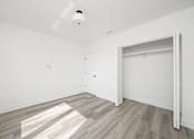 Thumbnail 23 of 27 - A room with a smoke detector on the ceiling and a door on the right.