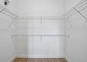 Thumbnail 26 of 46 - A white wall with a metal rack on top.