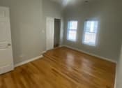 Thumbnail 14 of 14 - a living room with a hard wood floor and a ceiling fan