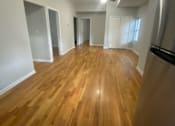 Thumbnail 13 of 14 - an empty living room with a wood floor