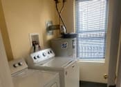 Thumbnail 12 of 14 - a small kitchen with a washing machine and a dryer