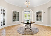 Thumbnail 52 of 71 - A large room with a round table in the middle and a chandelier hanging from the ceiling.
