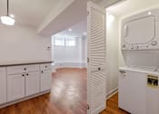 Thumbnail 4 of 13 - A white fridge in a kitchen with wooden floors.