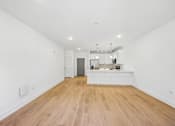 Thumbnail 38 of 60 - A room with wooden floors and white walls.