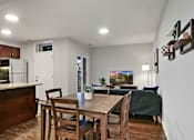 Thumbnail 10 of 15 - a dining room and living room with a table and chairs