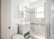 Thumbnail 6 of 15 - a white bathroom with a shower sink and toilet