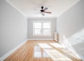 Thumbnail 11 of 15 - an empty room with a ceiling fan and a window