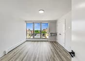 Thumbnail 45 of 54 - A spacious room with a view of the city through the window.