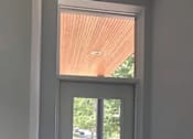 Thumbnail 38 of 45 - A doorway leading to a balcony with a view of a parking lot.