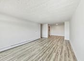 Thumbnail 32 of 54 - A room with wooden flooring and white walls.