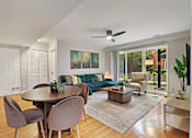 Thumbnail 25 of 31 - A modern living room with a dining table and chairs.
