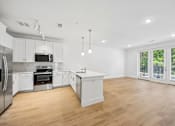 Thumbnail 39 of 60 - A modern kitchen with wooden floors and white cabinetry.