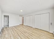 Thumbnail 30 of 54 - A room with wooden flooring and white walls.