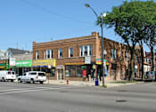 Thumbnail 1 of 14 - a brick building on the corner of a city street