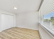 Thumbnail 42 of 54 - A room with a sliding door and a window with blinds.